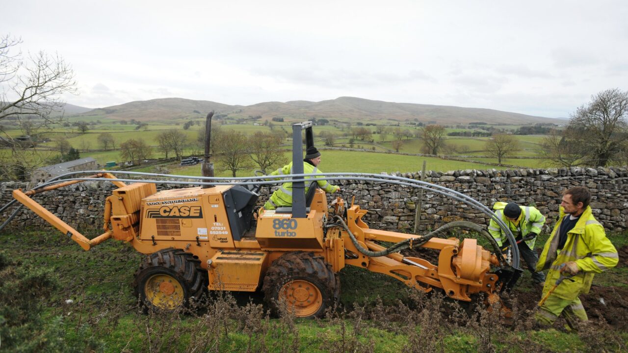 Engineers laying telecommunications cable as part of a broadband infrastructure project in rural Cumbria.