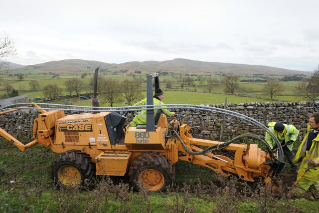 Engineers laying telecommunications cable as part of a broadband infrastructure project in rural Cumbria.