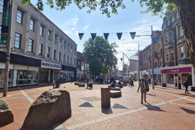 Broad Street in Reading with Marks & Spencer store frontage visible on the left side of the shopping street.