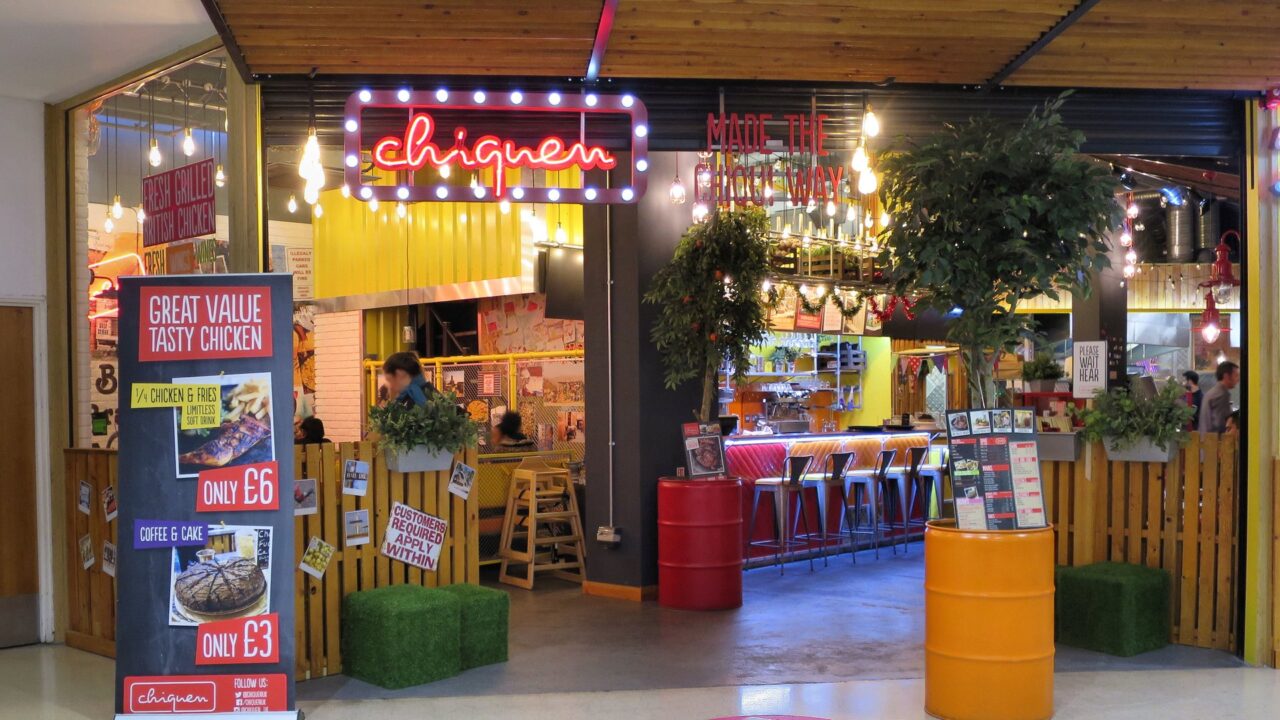 Interior of a retail shop unit in a UK shopping mall with customers shopping.