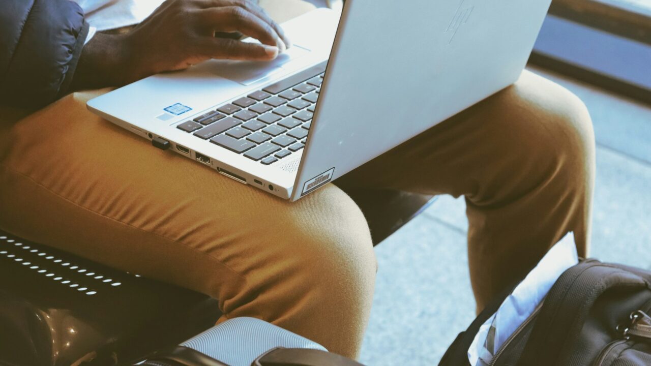 Person sitting on a chair using a laptop computer