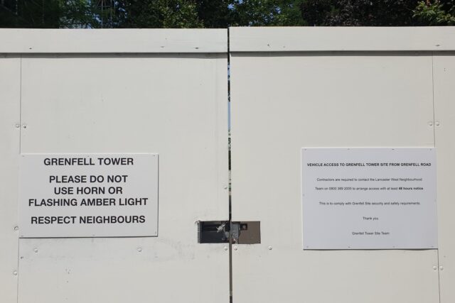 Grenfell Tower, a charred high-rise residential building in London, photographed during daylight.