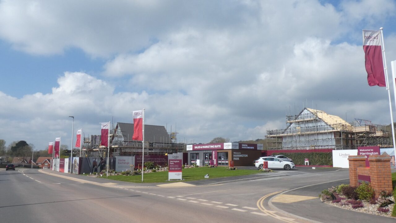 Construction site of new housing estate with building framework and cranes visible