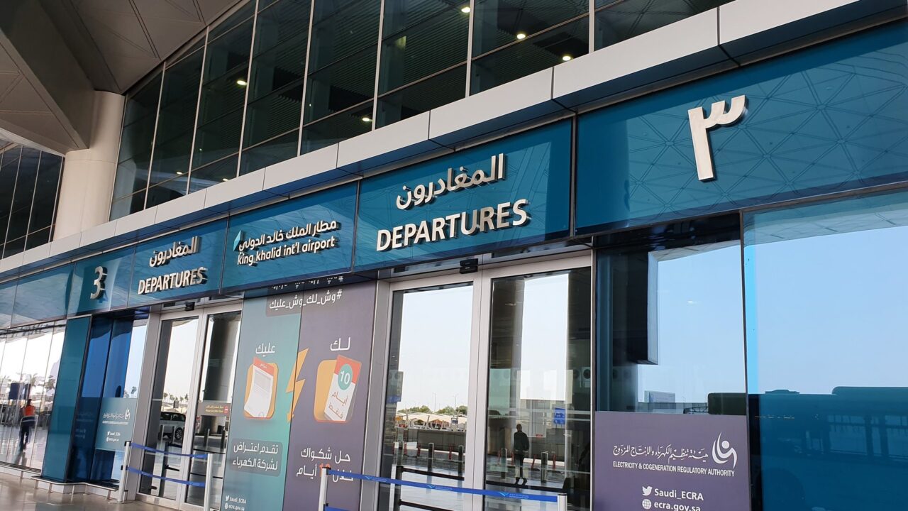 Interior view of airport departures area at Riyadh Airport with signage and passenger facilities