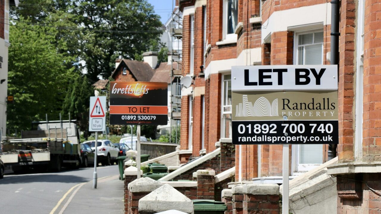 UK lettings agency sign on a building with phone number visible