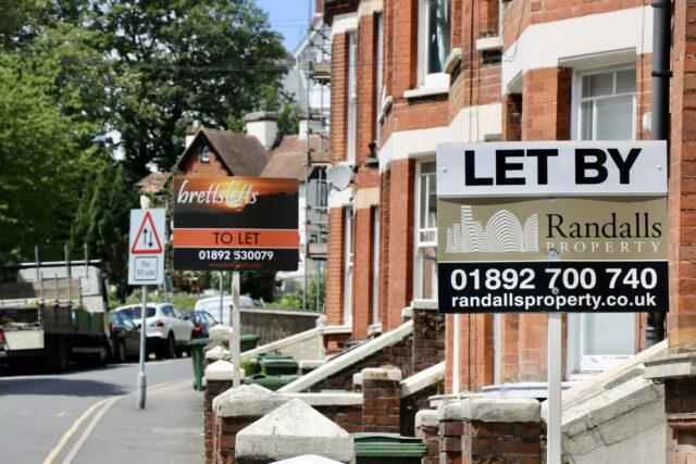 UK lettings agency sign on a building with phone number visible