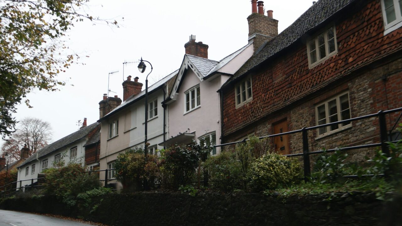 Row of traditional terraced houses along a UK street