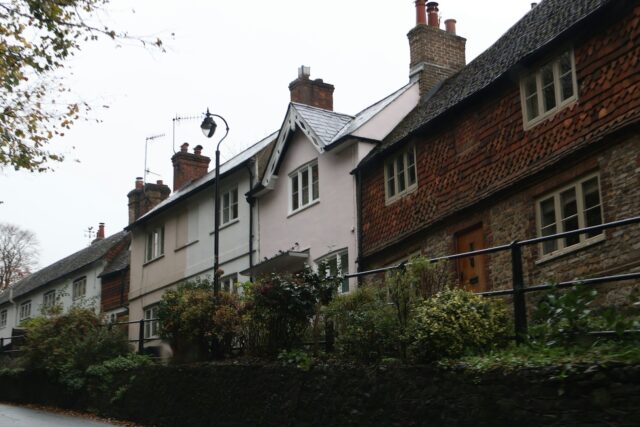 Row of traditional terraced houses along a UK street