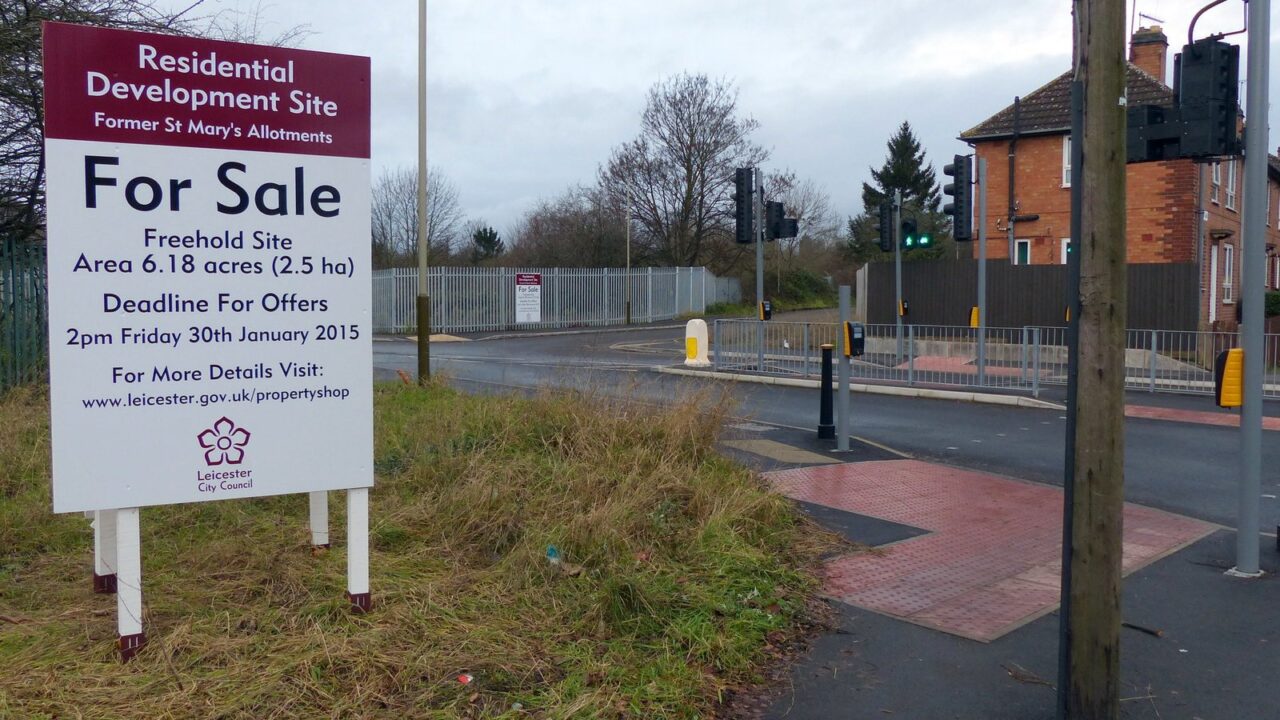 A for sale sign in front of a UK property
