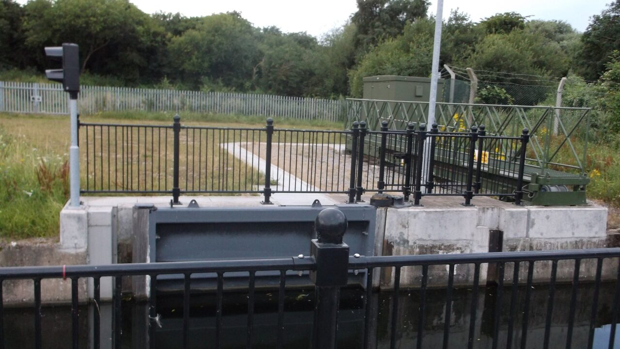 A sophisticated flood gate on the Erewash Canal near a bridge, part of Environment Agency flood defence systems.