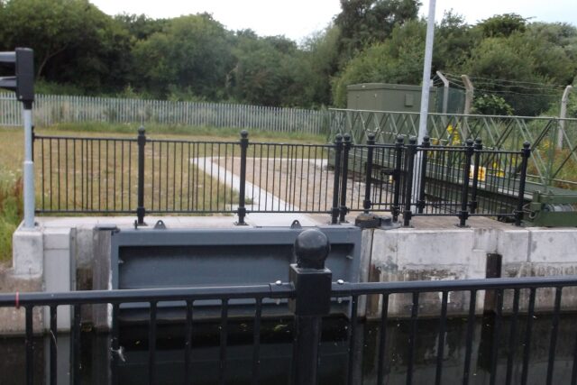 A sophisticated flood gate on the Erewash Canal near a bridge, part of Environment Agency flood defence systems.