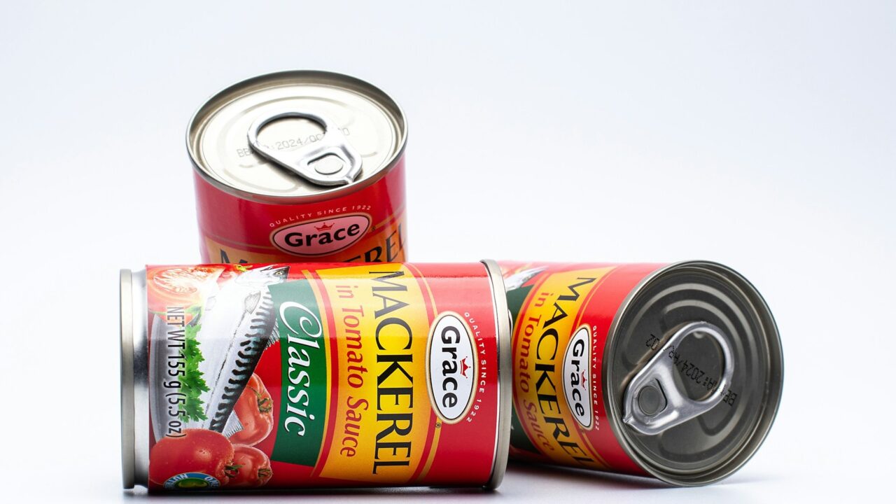 Two red tins of canned food stacked together against a white background