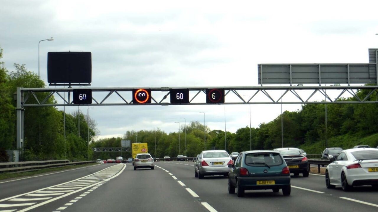 A motorway speed gantry displaying speed limits over the M42 motorway