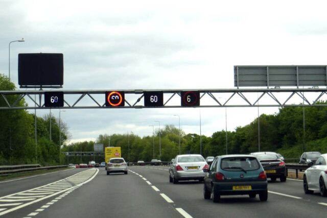 A motorway speed gantry displaying speed limits over the M42 motorway